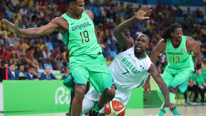 Nigeria forward Al-Farouq Aminu, right, loses control of the ball as he drives against Brazil guard Leandro Barbosa in a men's preliminary round Group B basketball game at Carioca Arena 1 during the Rio 2016 Summer Olympic Games.