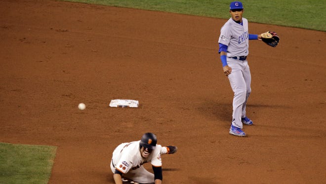 Game 4 in San Francisco: Cubs shortstop Addison Russell attempts a double play during the fourth inning.
