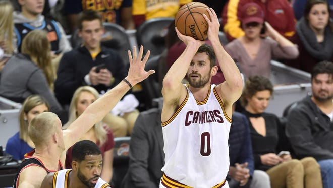 Cleveland Cavaliers forward Kevin Love (0) makes a three point basket in the first quarter against the Portland Trail Blazers at Quicken Loans Arena.