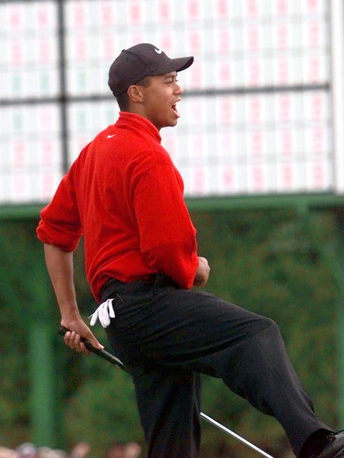 Tiger Woods celebrates at the 18th hole after winning  the 1997 Masters.