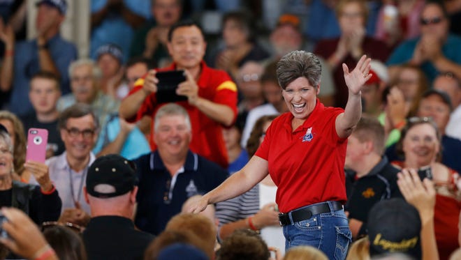 Sen. Joni Ernst waves at supporters as she takes the stage Saturday, Aug. 27, 2016, during the second annual Roast and Ride at the Iowa State Fairgrounds in Des Moines.