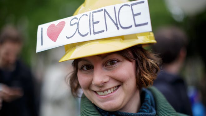 A woman participates in the March of Science in Vienna, Austria.