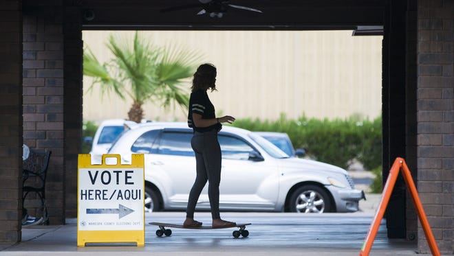 Tori Jensen, 18, rides her long board to Parkway Community Church in Phoenix to cast her ballot in Arizona's primary election on August 30 -- her first time voting.