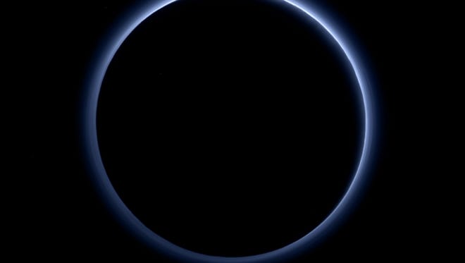 The dwarf planet may look like it has nothing in common with Earth, but new images from NASA show Pluto has blue skies and patches of icy water.
