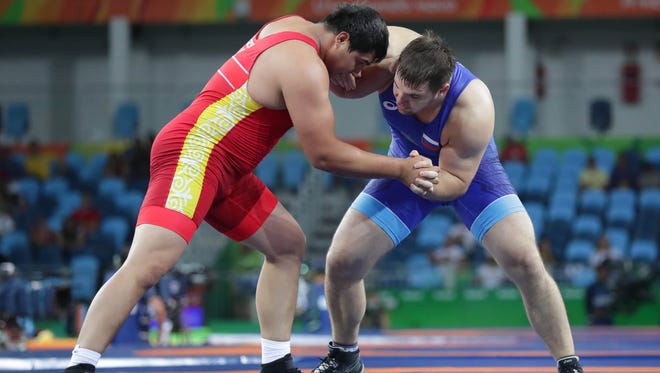 Ramonov of Kyrgyzstan and Sergey Semenov of Russia compete during the men's 130kg Greco-Roman wrestling qualifications in the Rio 2016 Summer Olympic Games at Carioca Arena 2.