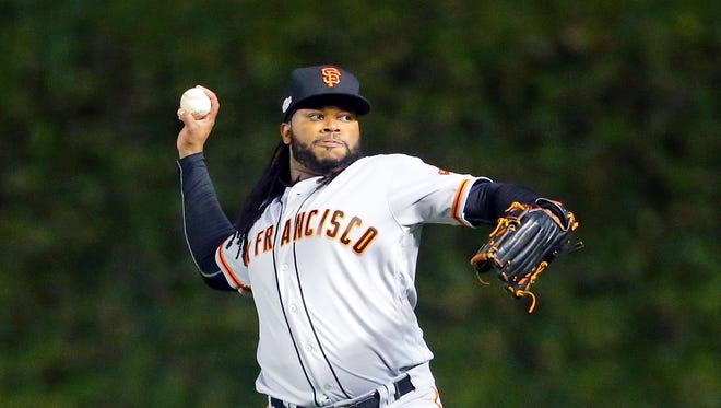 Game 1 in Chicago: Giants starting pitcher Johnny Cueto warms up.