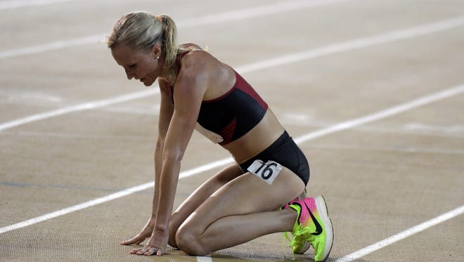 Shalane Flanagan drops to the track after finishing fourth in the 10,000.