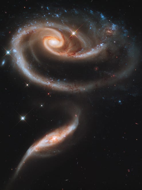 A "rose" made of galaxies highlights Hubble's 21st anniversary of deployment into space. Astronomers at the Space Telescope Science Institute in Baltimore, Md., pointed Hubble's eye to an especially photogenic group of interacting galaxies called Arp 273.