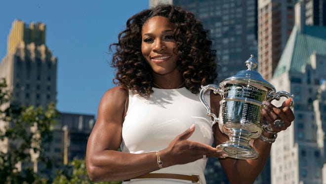 Serena Williams poses with the 2012 U.S. Open championship trophy in Central Park the day after defeating Victoria Azarenka in the women's singles final.