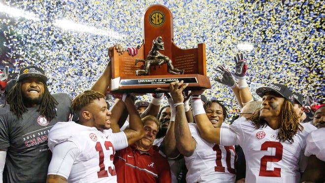 Alabama celebrates with its trophy after winning the SEC title game.