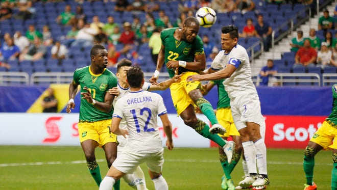 Jamaica forward Romario Williams (22) heads the ball against El Salvador midfielder Darwin Ceren (7) in the second half of the Gold Cup match at Alamodome.