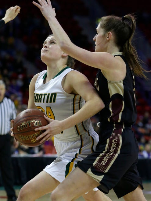 Greendale Martin Luther's Grace Amling (left) drives past Madison Edgewood's Katie Meriggioli during their WIAA girls basketball Division 3 state championship game.
