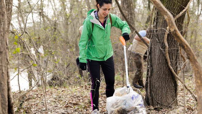 Caitlin Russo picks up trash along the banks of the Vermilion during a clean-up project held by Bayou Vermilion District and No Waste Louisiana Saturday, Feb. 4, 2017.