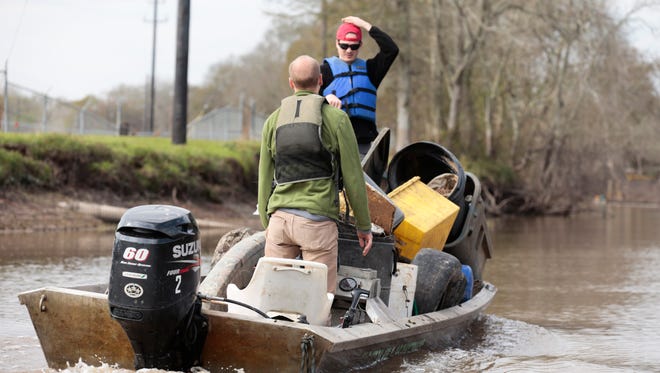 Brothers Louis, front, and Emile Ancelet haul trash picked up from the banks of the Vermilion during a clean-up project held by Bayou Vermilion District and No Waste Louisiana Saturday, Feb. 4, 2017.