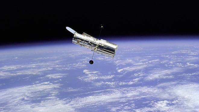 The Hubble Space Telescope is seen from the Space Shuttle Discovery in 1997.