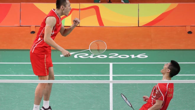 Nan Zhang and Haifeng Fu of China celebrate after beating Gi Jung  Kim and Sa Rang Kim of South Korea in a men's badminton doubles match at Riocentro - Pavilion 4 during the Rio 2016 Summer Olympic Games.