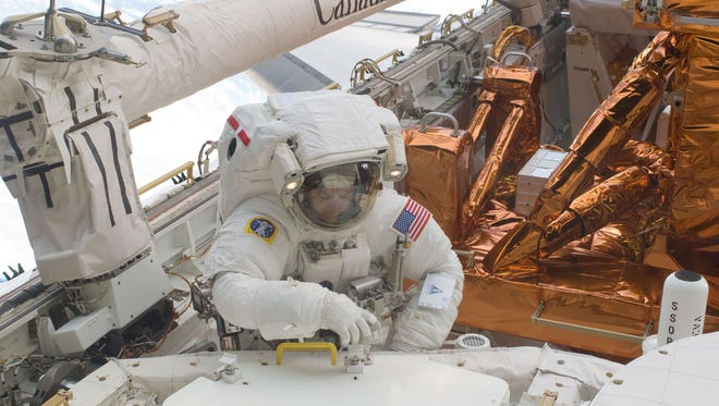 Mike Massimino works to refurbish and upgrade the Hubble Space Telescope during mission STS-125 on May 17, 2009. The mission, aboard space shuttle Atlantis, was the last shuttle mission to repair the telescope.