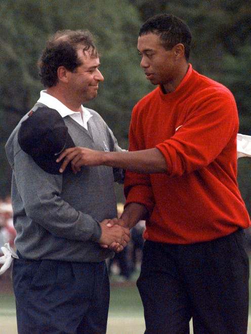 Masters champion Tiger Woods is congratulated by his playing partner Costantino Rocca, from Italy, after Woods set a course record during the final round of play at the Augusta National Golf Club in Augusta, Ga., on April 13, 1997.