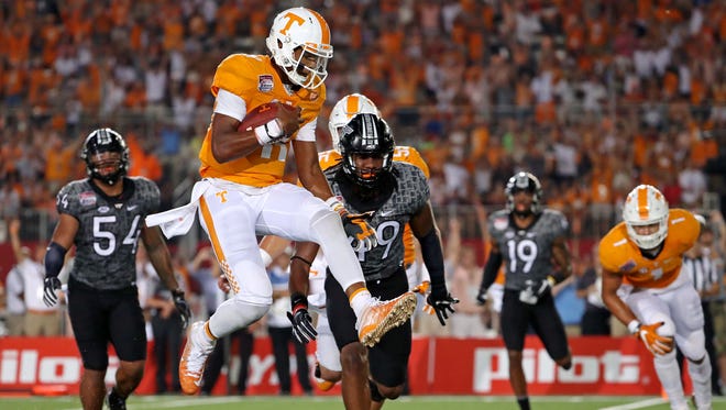 Tennessee Volunteers quarterback Joshua Dobbs (11) scores a touchdown against the Virginia Tech Hokies during the second quarter at Bristol Motor Speedway.
