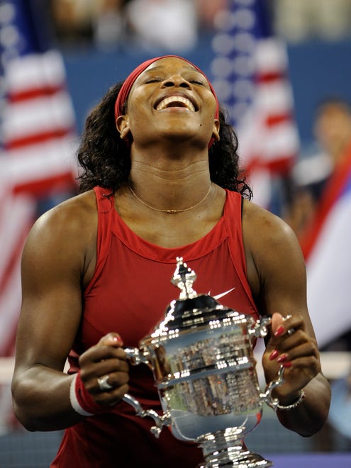 Serena Williams celebrates with the 2008 U.S. Open trophy after her win over Jelena Jankovic of Serbia.