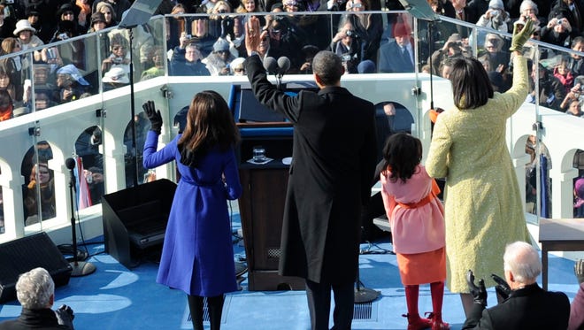 The Obamas wave from the West Front of the Capitol on Jan. 20, 2009.