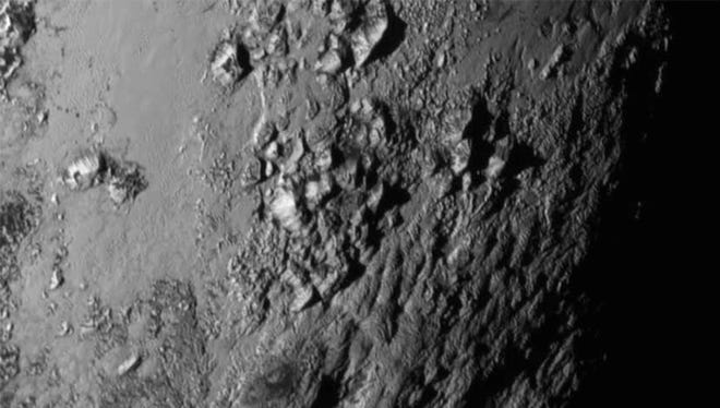 New close-up images of a region near Pluto’s equator reveal a giant surprise: a range of youthful mountains in this image from New Horizons’ Long Range Reconnaissance Imager (LORRI)