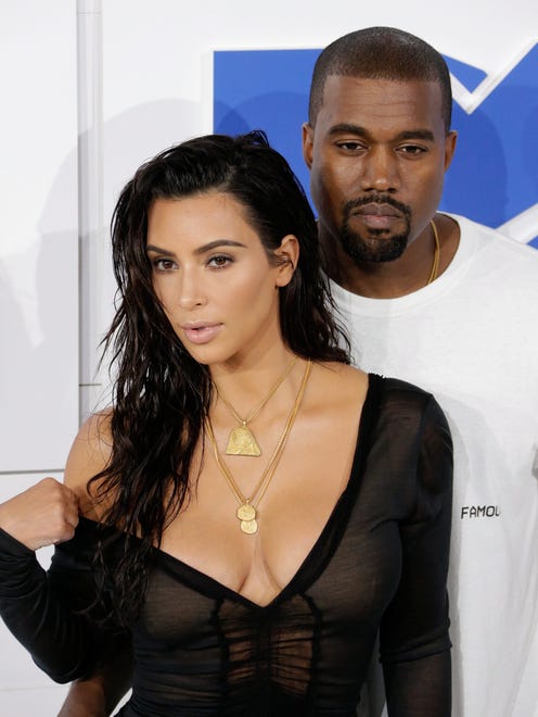 epa05567673 (FILE) A file photograph showing US entertainers Kim Kardashian (L) and husband Kayne West (R) arrive on the red carpet for the 33rd MTV Video Music Awards (VMA) at Madison Square Garden in New York, New York, USA, 28 August 2016. Reports on 03 October 2016 state that Kim Kardashian has been held at gunpoint and robbed of jewellery in her Paris hotel room.  Her husband US musician Kanye West stopped his concert in New York on hearing the news.  EPA/JASON SZENES *** Local Caption *** 52990030 ORG XMIT: JLX53