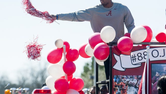 CFB National Championship Game MVP O.J. Howard throws pompoms and candy from a parade float as the town of Autaugaville, Ala. holds a parade in honor of Howard on Saturday February 27, 2016.