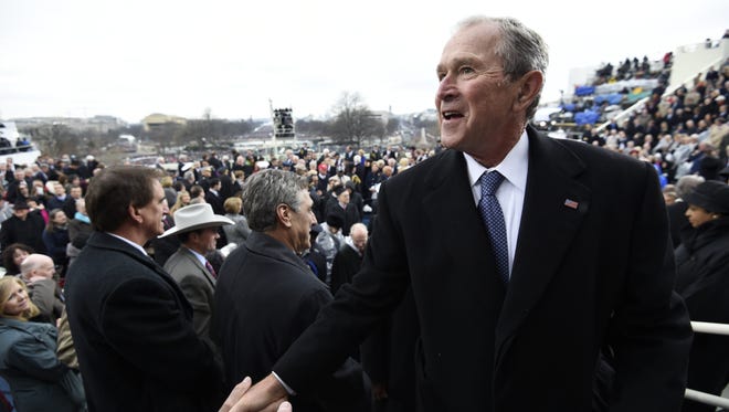 Former President George W. Bush leaves after the Presidential Inauguration.
