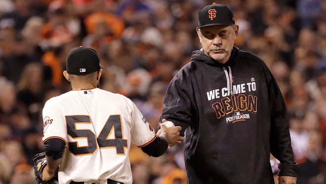 Bruce Bochy takes the ball from Sergio Romo for likely the last time, after Romo gave up an RBI double in the Cubs' four-run ninth inning.