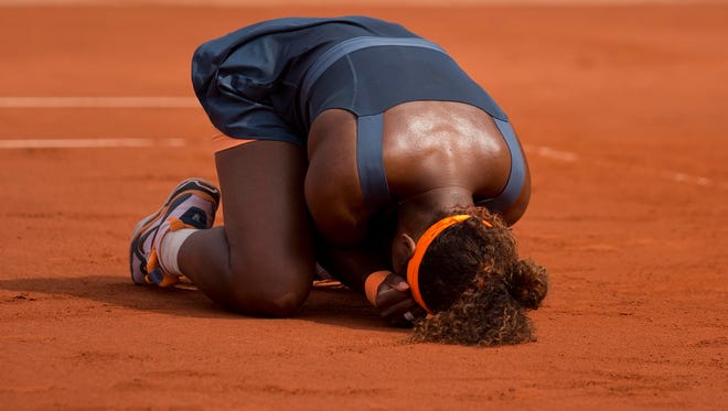 Serena Williams celebrates after recording match point against Maria Sharapova in the women's singles final of the 2013 French Open.