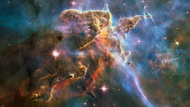 NASA's Hubble Space Telescope captured this billowing cloud of cold interstellar gas and dust rising from a tempestuous stellar nursery located in the Carina Nebula, 7,500 light-years away in the southern constellation Carina. Hubble's Wide Field Camera 3 observed the pillar on Feb. 1-2, 2010. The colors in this composite image correspond to the glow of oxygen (blue), hydrogen and nitrogen (green), and sulfur (red).