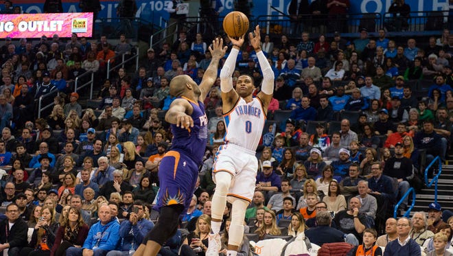 Oklahoma City Thunder guard Russell Westbrook (0) shoots over Phoenix Suns forward P.J. Tucker (17) during the second quarter at the Chesapeake Energy Arena.