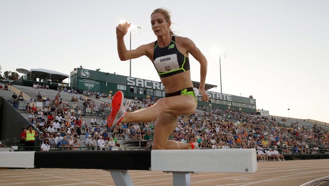 Emma Coburn clears a hurdle in the in the first round of the 3,000 steeplechase.