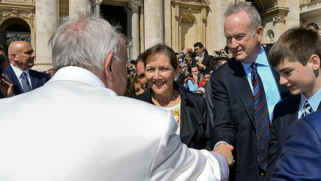 Pope Francis shakes hands with TV host Bill O'Reilly, second from right, during his weekly general audience, at the Vatican, Wednesday, April 19, 2017. O'Reilly is on a two-week vacation that on Wednesday took him to Francis' general audience in St. Peter's Square.