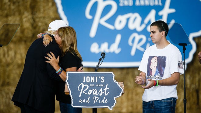 Republican Presidential candidate Donald Trump is accompanied by the family of Sarah Root during Sen. Joni Ernst her Roast and Ride event at the Iowa State Fairgrounds on Saturday, August 27, 2016 in Des Moines.