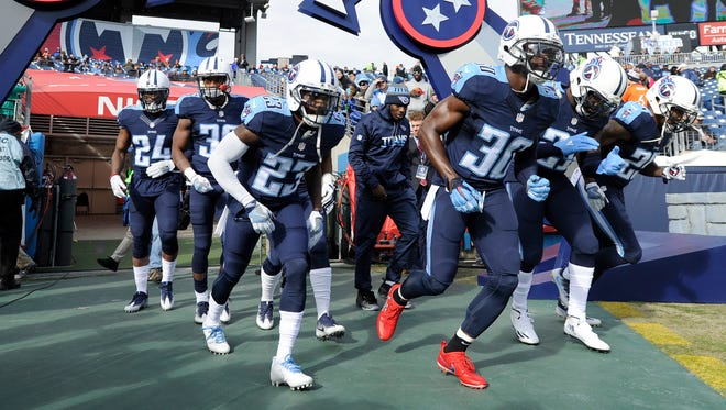 Titans cornerbacks Jason McCourty (30) and Brice McCain (23) and their teammates run onto the field before the game against the Broncos at Nissan Stadium Sunday, Dec. 11, 2016, in Nashville, Tenn.