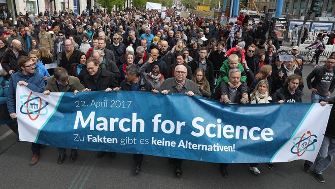 People march in support of scientific research during the March for Science demonstration in Berlin, Germany.