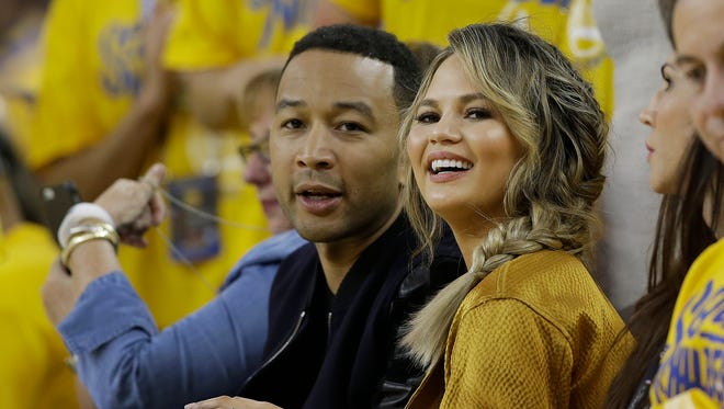John and Chrissy got sporty at an NBA Finals game between the Golden State Warriors and the Cleveland Cavaliers, also in June.