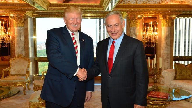 A handout photo provided by the Israeli Government Press Office shows Donald Trump (L) shaking hands with Israeli Prime Minister Benjamin Netanyahu at Trump Tower in New York, on Sept. 25, 2016.