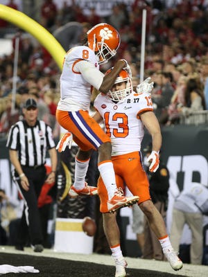 Clemson receivers Hunter Renfrow (13) and Deon Cain (8) celebrate a TDin the title game.