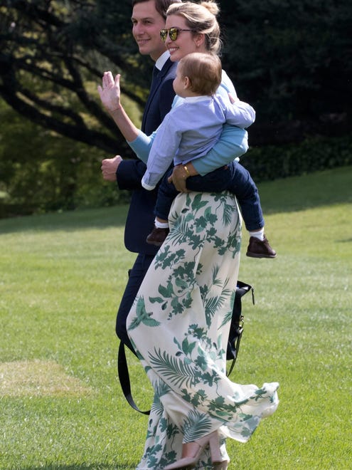 eJared Kushner and Ivanka Trump and their younger son Theodore on the South Lawn of the White House headed for the weekend at Camp David, on Aug. 25, 2017. She is wearing palazzo pants patterned with green fronds and a blue top with high chunky suede heels.