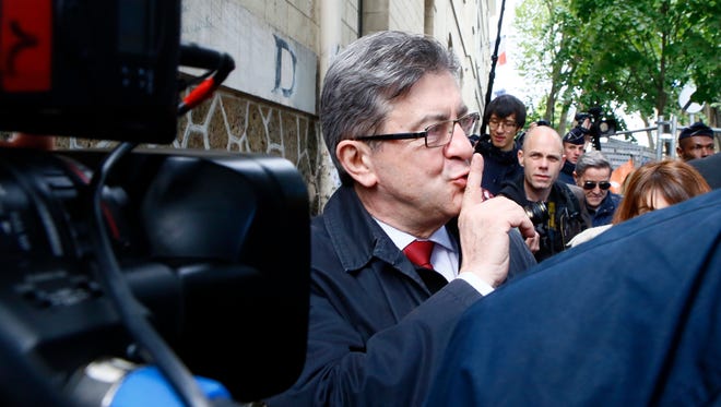 Far-left presidential candidate Jean-Luc Melenchon reacts after voting in the first round of the French presidential election, in Paris.