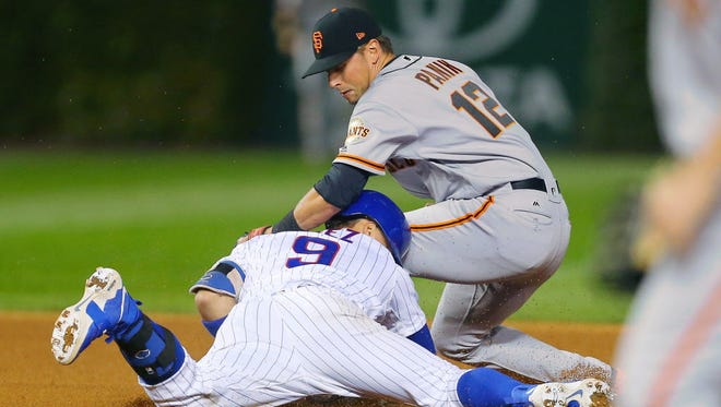 Game 2 at Chicago: Cubs second baseman Javier Baez is tagged out at second base by Giants second baseman Joe Panik during the sixth inning.