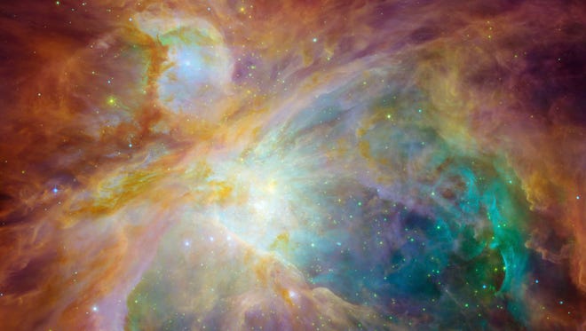 this image from NASA's Spitzer and Hubble Space Telescopes looks more like an abstract painting than a cosmic snapshot. The magnificent masterpiece shows the Orion nebula in an explosion of infrared, ultraviolet and visible-light colors. It was "painted" by hundreds of baby stars on a canvas of gas and dust, with intense ultraviolet light and strong stellar winds as brushes.