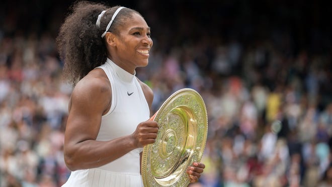Serena Williams poses with the Wimbledon trophy after defeating Angelique Kerber 7-5, 6-3 for her 22nd major title.