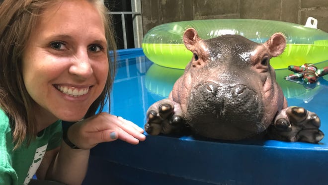 Cincinnati zookeeper Wendy Rice poses in 
April 2017 with Fiona, a Nile hippo born prematurely Jan. 24, 2017, at Cincinnati Zoo & Botanical Garden.