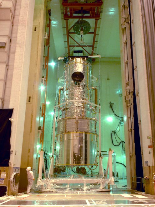 Hubble is lifted into the upright position in Lockheed Martin's acoustic vibration chamber in preparation for its 1990 launch aboard the Space Shuttle Discovery. The telescope was designed and built in the 1970s and 1980s, but its launch was delayed by the Space Shuttle Challenger disaster in 1986. A close look at this image reveals a portion of the 225 feet of handrails installed around the outside for astronauts to grip during repair mission spacewalks.