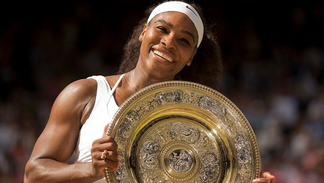 Serena Williams poses at the trophy presentation after winning her match against Garbiñe Muguruza to claim the 2015 Wimbledon women's singles title.