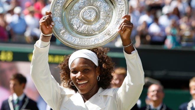 Serena Williams holds the 2009 Wimbledon trophy after defeating her sister Venus on Centre Court.